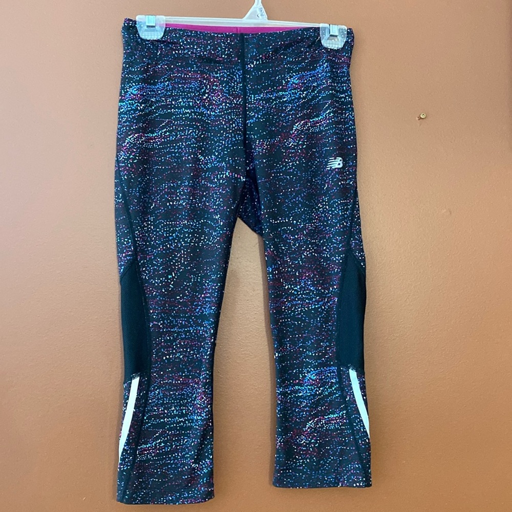 New balance ladies tights in size small with reflective strips and mesh inserts.